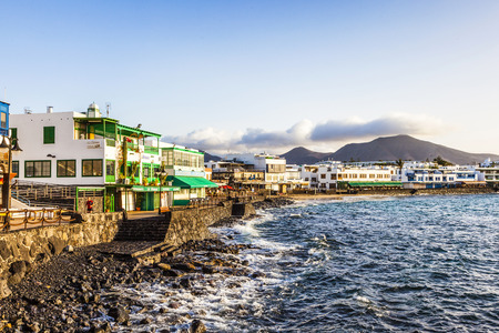 PLAYA BLANCA, SPAIN - DEC 29, 2010: promenade of scenic Playa Blanca with seaside in the morning. Playa Blanca became a major touristic town since 1985.のeditorial素材