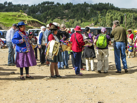 SACSAYHUMAN, LIMA - JAN 11, 2015: locals sell souvenirs to tourists at Inca ruins in the peruvian Andes at Cuzco, Peruのeditorial素材