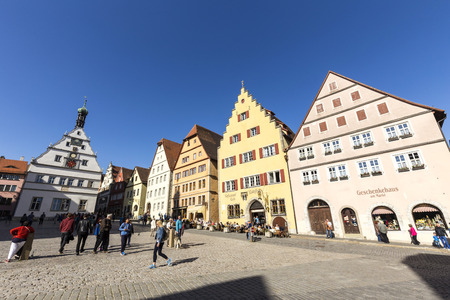 ROTHENBURG, GERMANY - APR 19, 2015: people at the market place of Rothenburg ob der Tauber, Germany. The medieval town attracts over 2 million visitors every year.のeditorial素材