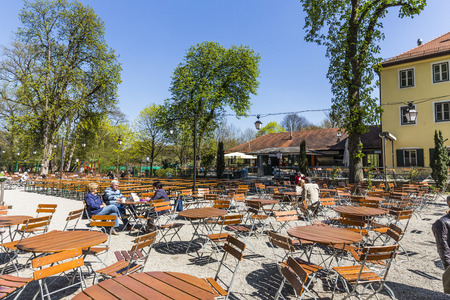 MUNICH, GERMANY - APR 20, 2015: people enjoy the  Hirschgarten near Chinese tower in English garden in Munich, Bayern, Germany.のeditorial素材