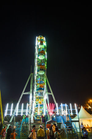 DELHI, INDIA - NOV 11, 2011: people enjoy the big wheel in the amusement park in Delhi, India in front of the red fort. The prices are very low to enable poorer people a ride.のeditorial素材
