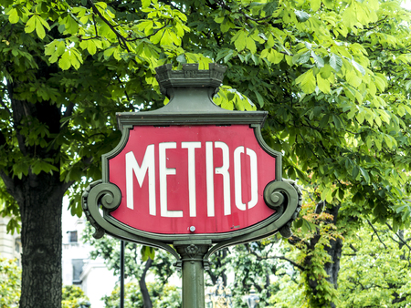 Parisian metro sign with a lamppost against old vintage wallのeditorial素材
