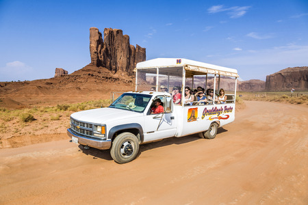 MONUMENT VALLEY, USA - JULY 12, 2008: people enjoy the ride through the scenic Buttes in the Monument Valley, USA.  The park is run by Navajo Indians.のeditorial素材
