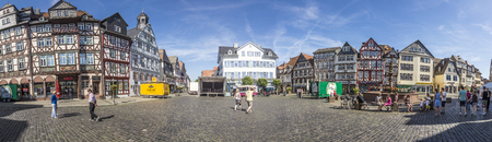 BUTZBACH, GERMANY - JUNE 4, 2015: people enjoy the beautiful medieval market place in Butzbach, Germany. In 143 the market place was build with cobble stones and the still existing fountain.のeditorial素材