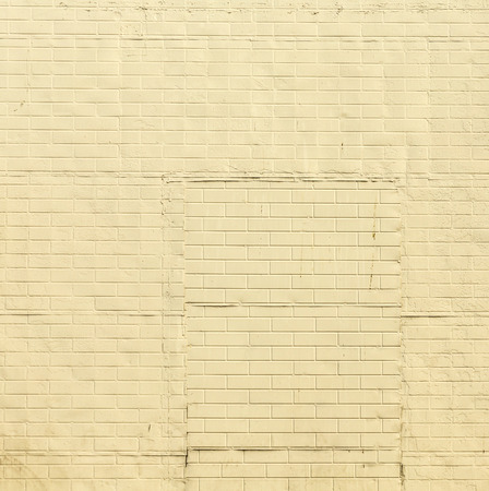 old brick wall painted with color in sunlightの写真素材