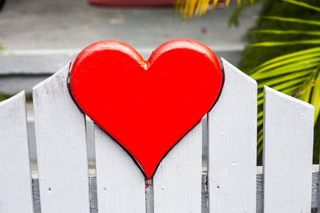 heart shape at a fence in red colorの写真素材