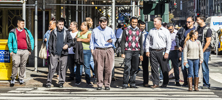 NEW YORK, USA - OCT 21 2015: people crossing a street at a pedestrian crossing in New York. New York State averages nearly 300 pedestrian fatalities annually.のeditorial素材