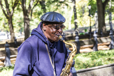 NEW YORK, USA - OCT 21, 2015: Performer plays sax at Central Park in New York, USA. One of the 5 boroughs of New York City, the smallest but also the most populatedのeditorial素材