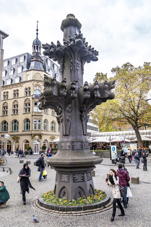 COLOGNE, GERMANY- NOV 5, 2015: Tourists in front of the replica of the top stone of the Cathedral in Cologne, Germany. It is Germanys most visited landmark visited by 20.000 people a day.のeditorial素材