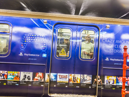 NEW YORK, USA - OCT 21 2015: People look out of a train at subway station times square in New York. With 1.75 billion annual ridership, NYC Subway is the 7th busiest metro system in the world.のeditorial素材
