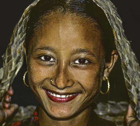 POKHARA, NEPAL - AUG 18, 1985: young female girl is happy and smiles in Pokhara, Nepal. Young girls mostly work on fields in rural area after primary school.のeditorial素材