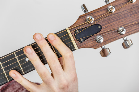detail of fingers, string and hand of guitar player