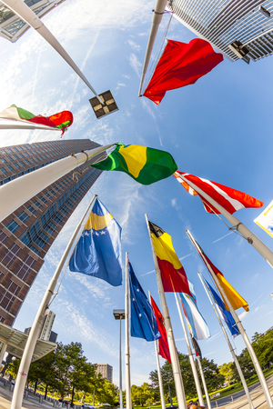 FRANKFURT, GERMANY - SEP 12, 2010: flags at Messeturm in Frankfurt, Germany. - Fair Tower of Frankfurt, Germany. The tower was in 1990 Europes tallest building with 257 m (843 ft).のeditorial素材
