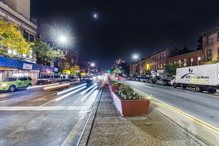 NEW YORK, USA - OCT 20, 2015: night view in Brooklyn Park slope of main street with headlights of...