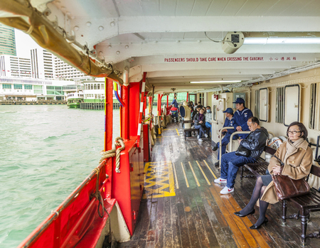 HONG KONG - JAN 09, 2010: passenger on upper deck of a Star Ferry. The Star Ferry is a passenger ferry service operator and tourist attraction in Hong Kongのeditorial素材