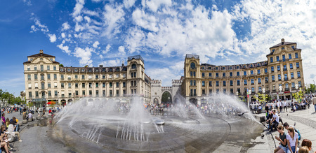 Munich, Germany - MAY 27, 2016: People walking along through the Karlstor gate in Munich and refresh at the water fountain.のeditorial素材