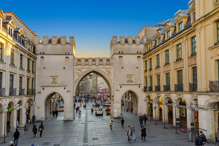 Munich, Germany - DEC 24, 2014: People walking along through the Karlstor gate in Munic