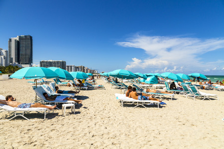 MIAMI, USA - AUG 1, 2013: people enjoy the hot summer day at south beach in Miami, USA. South beach is the famous beach at art deco district neaqr ocean drive street.のeditorial素材
