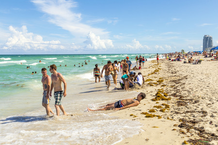 MIAMI, USA - AUG 1, 2013: people enjoy the hot summer day at south beach in Miami, USA. South beach is the famous beach at art deco district neaqr ocean drive street.のeditorial素材