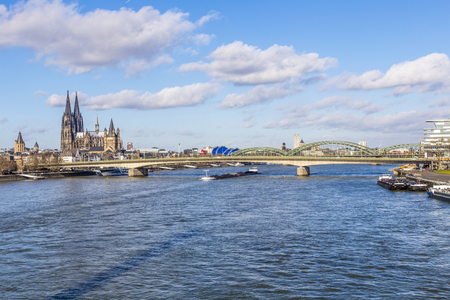 COLOGNE, GERMANY - FEB 12, 2014: Cologne skyline with cathedral  and ships on river Rhine, the central transportation route from north to south Germany,のeditorial素材