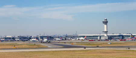NEW YORK, USA - OCT 20, 2015: Air Traffic Control Tower and Terminal 4 with Air planes at the gates in JFK Airport in NY. 1963 the airport was rededicated John F. Kennedy International Airport.のeditorial素材