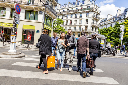 PARIS, FRANCE - JUNE 9, 2015: people at Rue de Rivoli. It is one of the most famous streets of Paris, a commercial street whose shops include the most fashionable names in the world.のeditorial素材