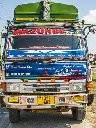 TANZANIA, DAR ES SALAAM - JULY 23, 2016: colorful overland truck to serve the highway to Dar Es Salaam. Roads are the main transportation way in Tanzania.のeditorial素材