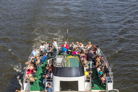 FRANKFURT, GERMANY - OCT 28, 2013: people enjoy the trip on river Main on a sunny day. Many tourists do excursion trips by boat on river Main.のeditorial素材