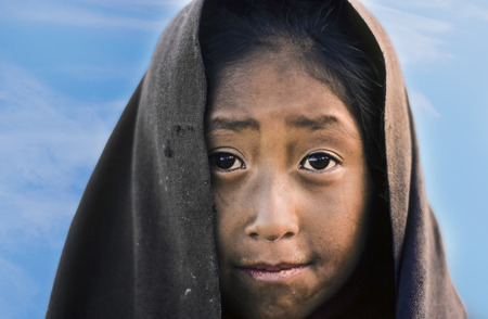 TAQUILE, PERU - APR 4, 1986: portrait of young farmer girl in early morning with rags at the peruan...