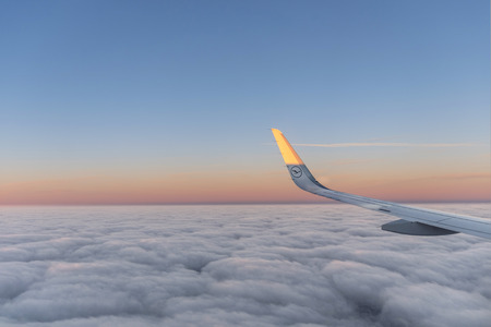 HAMBURG, GERMANY - JAN 19, 2017: bright sun at the wing of a Lufthansa aircraft flying in sunriseのeditorial素材
