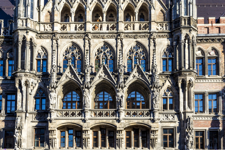 facade of new munich town hall under blue skyの写真素材