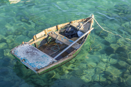 old rotten fisher boat swims at the oceanの写真素材