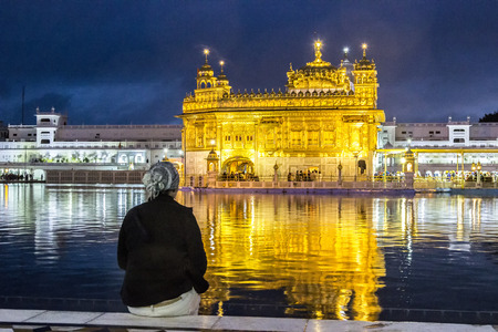 AMRITSAR, INDIA - FEB 23, 2013: people admire the  Harimandir Sahib at the Golden temple complex, Amritsar - Indiaのeditorial素材