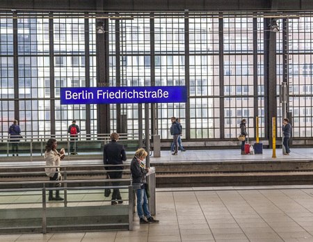 BERLIN, GERMANY - MAY 3, 2016: Railstation Berlin Friedrichstrasse with people waiting for trainのeditorial素材