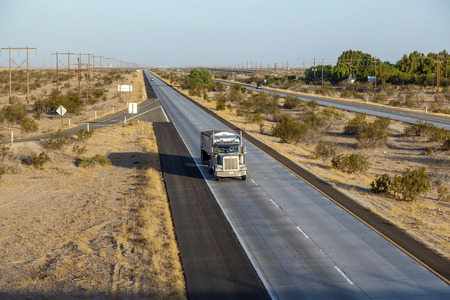 YUMA, USA - JUNE 11, 2012: truck on  interstate 8 in the desert area of Arizona in morning lightのeditorial素材