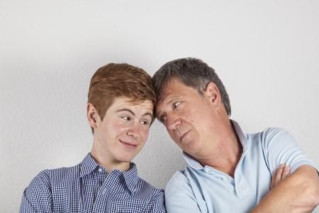 father and son hugging with head to headの写真素材