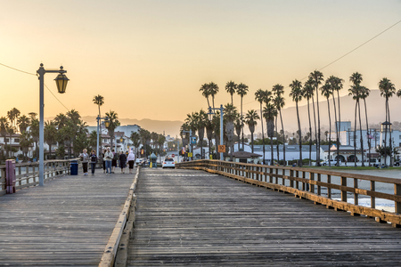 SANTA BARBARA, USA - JULY 28, 2008: people at scenic old wooden pier in Santa Barbara in sunset. The pier was completed in 1872 and was the longest pier at that time in the USA.のeditorial素材