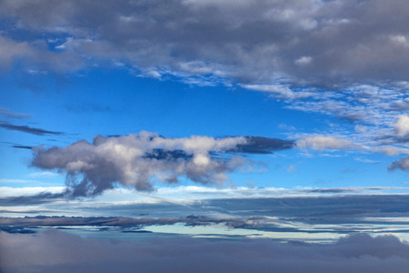 aerial of blue sky with dark raining clouds gives a dramatic backgroundの写真素材