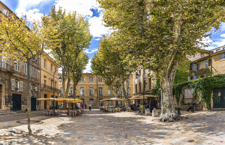 AIX EN PROVENCE, FRANCE - AUG 11, 2017: people enjoy resting at a tree covered place in the  old town of charming Aix en Provence. The old roman city was in former times the capital of the provence.のeditorial素材