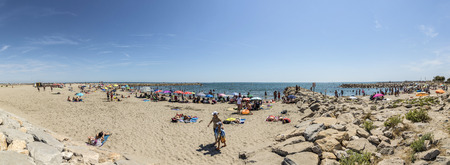 SAINTES MARIES DE LA MER, FRANCE - AUG 15, 2017: people enjoy the sandy beach on a hot summer day, The beach in the Camargue stretches over 10 miles.のeditorial素材