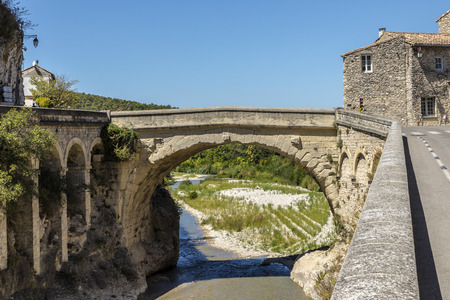 view to roman bridge and old town in vaison la romaineの写真素材