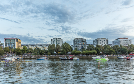 FRANKFURT, GERMANY - AUG 24, 2017: people on boats listen and look to the orchestra of the hesse broadcast which play at the weseler wharf near the new ECB building. The performance ist free of charge.のeditorial素材