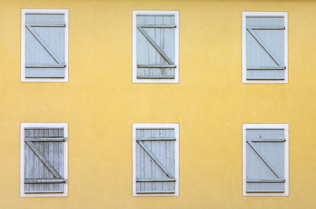 facade with closed shutter in harmonic patternの写真素材