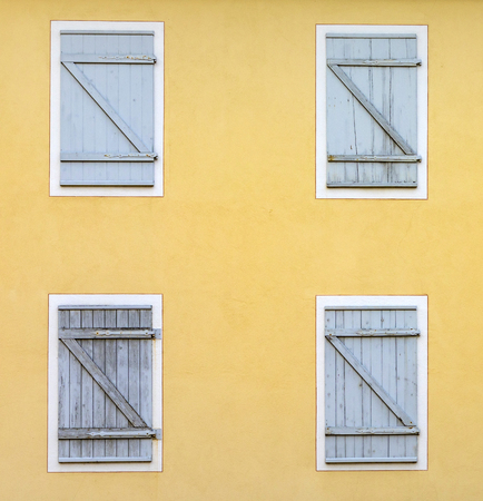facade with closed shutter in harmonic patternの写真素材