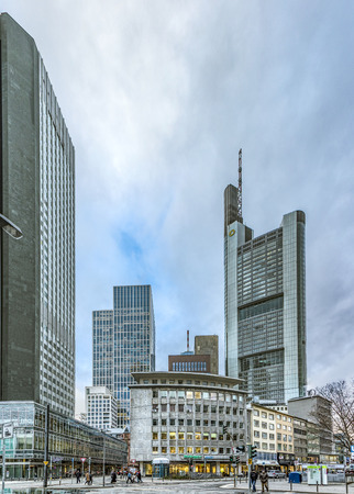 FRANKFURT, GERMANY - JAN 13, 2017: downtown view to Neue Mainzer Landstrasse, old buildings and modern skyscraper with people at the street in Frankfurt.のeditorial素材