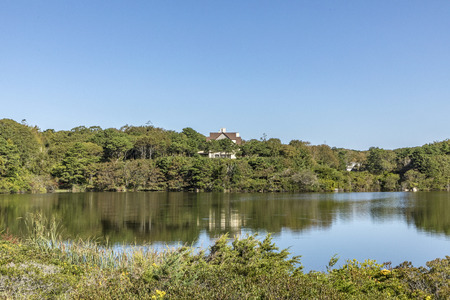 FALMOUTH, USA - SEP 24, 2017: many expensive mansion houses  with huge private area landscape are placed at the atlantic ocean and small lakes nearby in Falmouth, USA.のeditorial素材