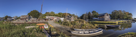 ESSEX, USA - SEP 29, 2017: panoramic river landscape with boats and Essex shipbuilding museum and wharf in ESSEX, New England, USAのeditorial素材