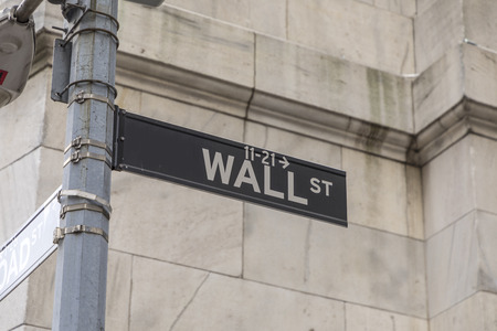 NEW YORK, USA - OCT 5, 2017: Wall street sign in lower  Manhattan with history of New York stock exchange and man in black.のeditorial素材