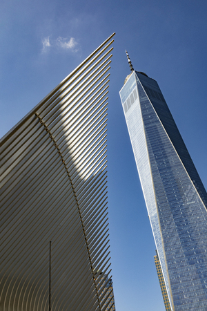 NEW YORK, USA - OCT 6, 2017: Distinctive architectural form of the Oculus transportation hub stands in front of a bright view of the One World Trade Center tower.のeditorial素材
