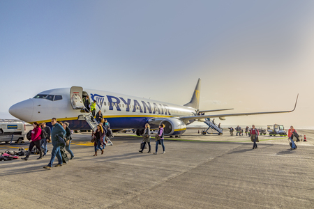 ARRECIFE, SPAIN - JAN 18, 2017: passengers arriving with Ryanair at the airport of Lanzarote and go to terminal without passenger bridge.のeditorial素材
